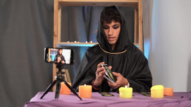 Fortune teller reading tarot cards on smartphone modern horoscopes online fortune telling application Psychic readings and clairvoyance