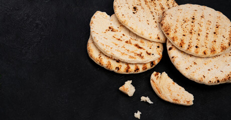 .Pita bread on dark background. Arabic, lebanese bread, traditional food.