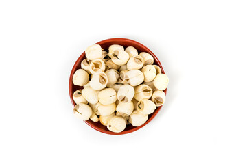Lotus seeds in a red and black bowl isolated over white background top down view - obrazy, fototapety, plakaty