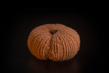 Yellow-orange pumpkins on a black background the concept of Halloween and the autumn harvest of pumpkin close-up copyspace from above