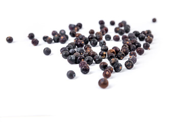 Juniper berries scattered background isolated over white side view