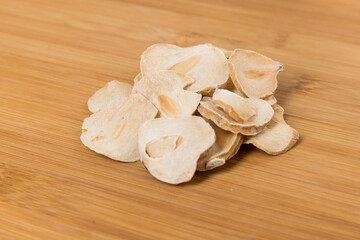 Sliced dried shallots in a pile on a wood cutting board