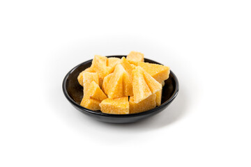 Saffron spiced sugar cubes in a pile on a black bowl side view