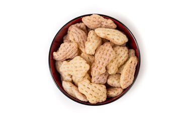 Cuttlefish snack crisps in an orange bowl isolated over white top down