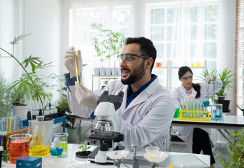 asian botanist working at lab