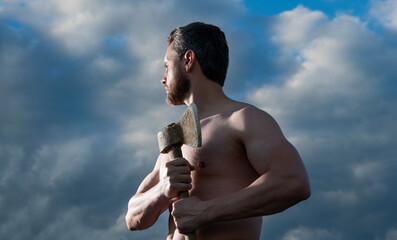 shirtless man with axe. brutally man hold ax. brutal man on sky background