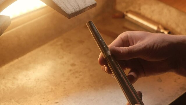 Close up of artisanal jeweler fitting ring size in workshop.