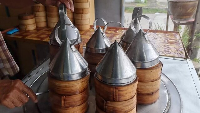 tiered bamboo tray which is steaming traditional chinese dim sum