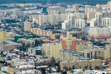 winter panoramic aerial view of a huge residential complex with high-rise buildings with snow