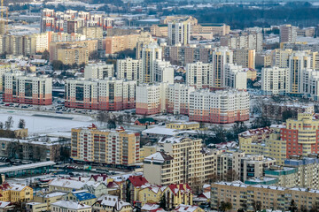 Fototapeta na wymiar winter panoramic aerial view of a huge residential complex with high-rise buildings with snow