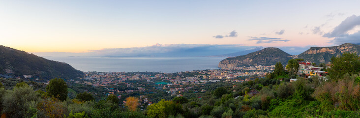 Fototapeta na wymiar View of Touristic Town, Sorrento, Italy. Coast of Tyrrhenian Sea. Cloudy Sky Sunset. Panorama