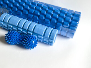 A blue foam massage roller. Blue double or peanut spikey ball massager for yoga pilates or...