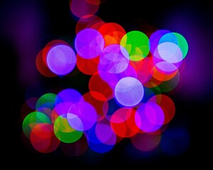 Multi-colored orbs created from the lights of the Christmas tree.