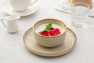 Portion of healthy sweet porridge with banana and jam