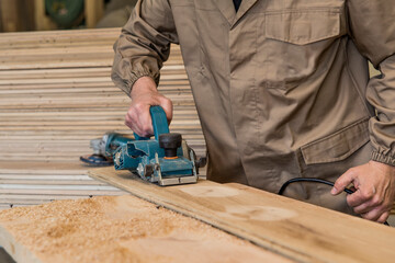 carpenter using grinder on wood