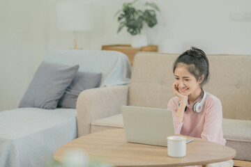 Asian woman watching movies, listening to music, video calling at home.