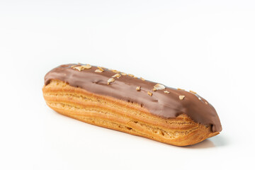 Traditional French pastry. Eclair with custard and chocolate icing isolated on white background. Eclair with cream filling covered with melted milk chocolate