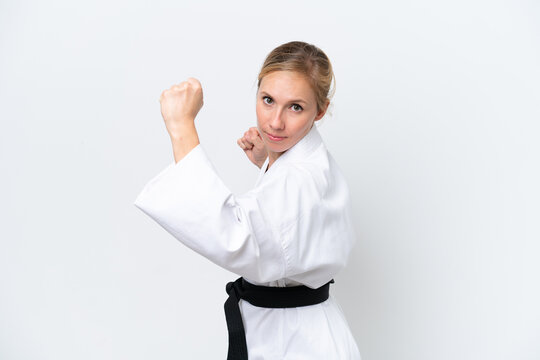 Young caucasian woman isolated on white background doing karate