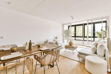 Contemporary minimalist style interior design of light studio apartment with wooden table and...
