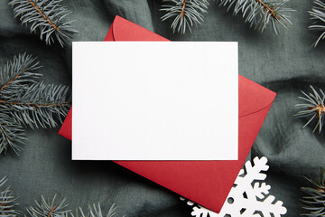 Christmas greeting card mockup with holiday decorations on green background, top view