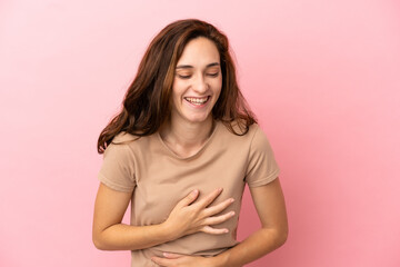 Obraz premium Young caucasian woman isolated on pink background smiling a lot