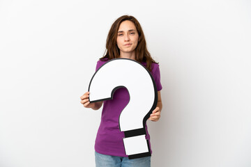 Young caucasian woman isolated on white background holding a question mark icon and with sad...