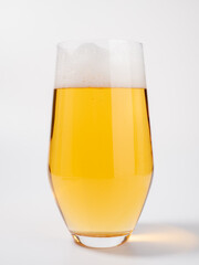 Glass of beer on a white background. A glass of light beer with foam.