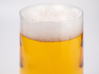Glass of beer on a white background. A glass of light beer with foam.