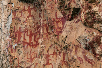 Petroglyphs on the wall of Zuojiang Huashan Rock Art, background image of the ancient paintings