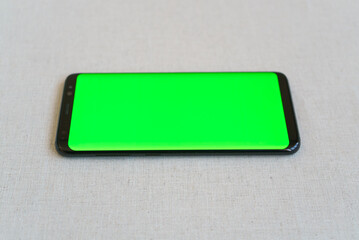 Mobile phone on table horizontally with blank screen