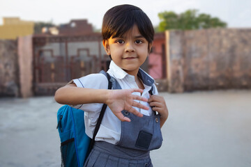 Rural Indian school girl saying bye while going to school