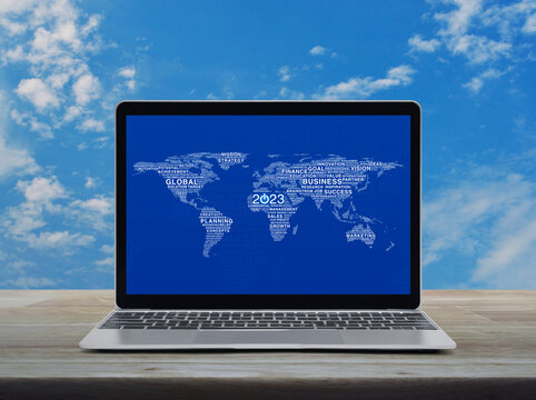 Start up 2023 business icon with global words world map with laptop computer on table over sky, Happy new year 2023 global business start up online concept, Elements of this image furnished by NASA