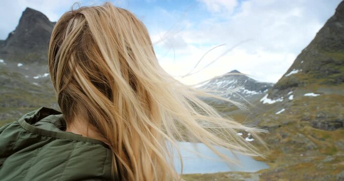 Travel, mountains and peace of woman hiking in Norway for adventure, journey and sightseeing. Trekking, freedom and thoughtful face of girl with appreciation for nature on holiday in Europe.