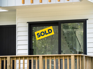 Sold property sign sticker on sliding patio door.