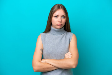 Young Lithuanian woman isolated on blue background feeling upset