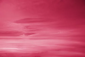 Trendy color of the year 2023. Sky with rain clouds toned in viva magenta color.sky abstract background, beautiful cloudscape, on the heaven, view over white fluffy clouds, freedom concept