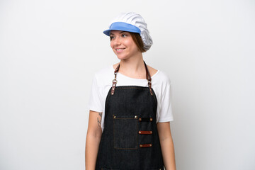 Fishmonger woman wearing an apron looking to the side and smiling