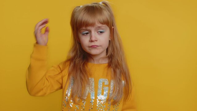 Dont want to hear, listen. Frustrated annoyed irritated young toddler school girl in sweater covering ears, gesturing No, avoiding advice ignoring unpleasant noise loud voices. Teen female child kid