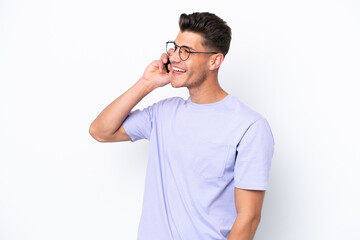 Young caucasian man isolated on white background keeping a conversation with the mobile phone