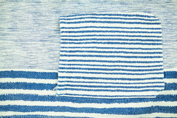 Fototapeta na wymiar Close up of the pocket with white and blue striped shirt. Top view