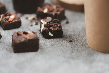 Chocolate brownies topped with chocolate chips and almonds slice, The texture is crunchy on the outside but soft on the inside