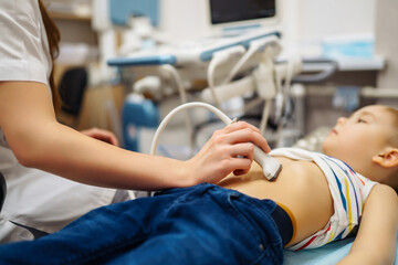 Little boy undergoing  ultrasound at clinic. doctor making abdominal cavity sonogram for child