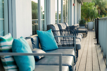 Steel sofas with cushions on a deck with wooden flooring at Miami, Florida