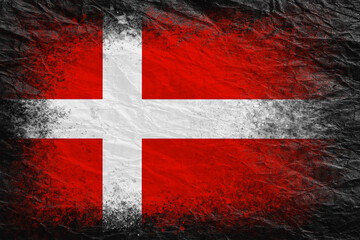 Flag of Denmark. Flag is painted on black crumpled paper. Paper background. Copy space. Textured background