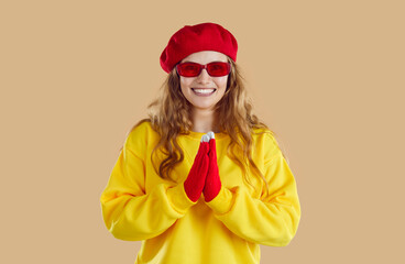 Portrait of excited happy woman who joyfully claps her hands in anticipation of something pleasant....