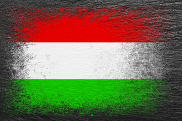 Flag of Hungary. Flag is painted on black slate stone. Stone background. Copy space. Textured background