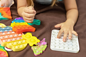 Pop it is a multi-colored anti-stress toy in children's hands. Bubble game. Antistress toys.