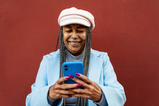 Senior African Woman Using Mobile Smartphone Outdoor