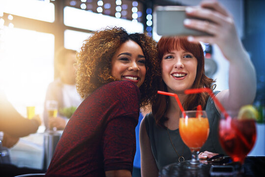Friends, smartphone selfie and smile with drinks at party or year end event, night out and celebration together. Women, happy and celebrate friendship with photograph, love and support with cocktail