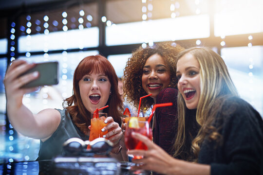 Women, friends and phone selfie at club with drinks, having fun or bonding. Night, celebration and group of girls taking a photo on mobile smartphone for happy memory, social media or profile picture